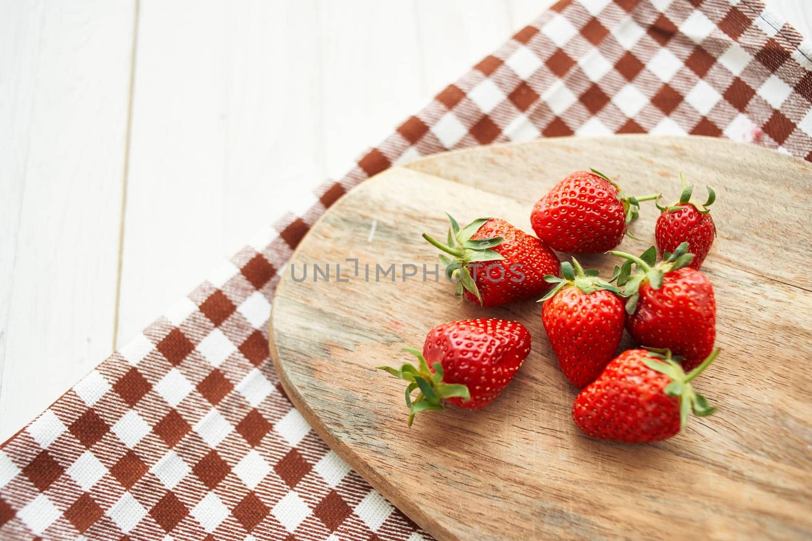 fresh strawberries on wooden board fruit vitamins summer by Vichizh