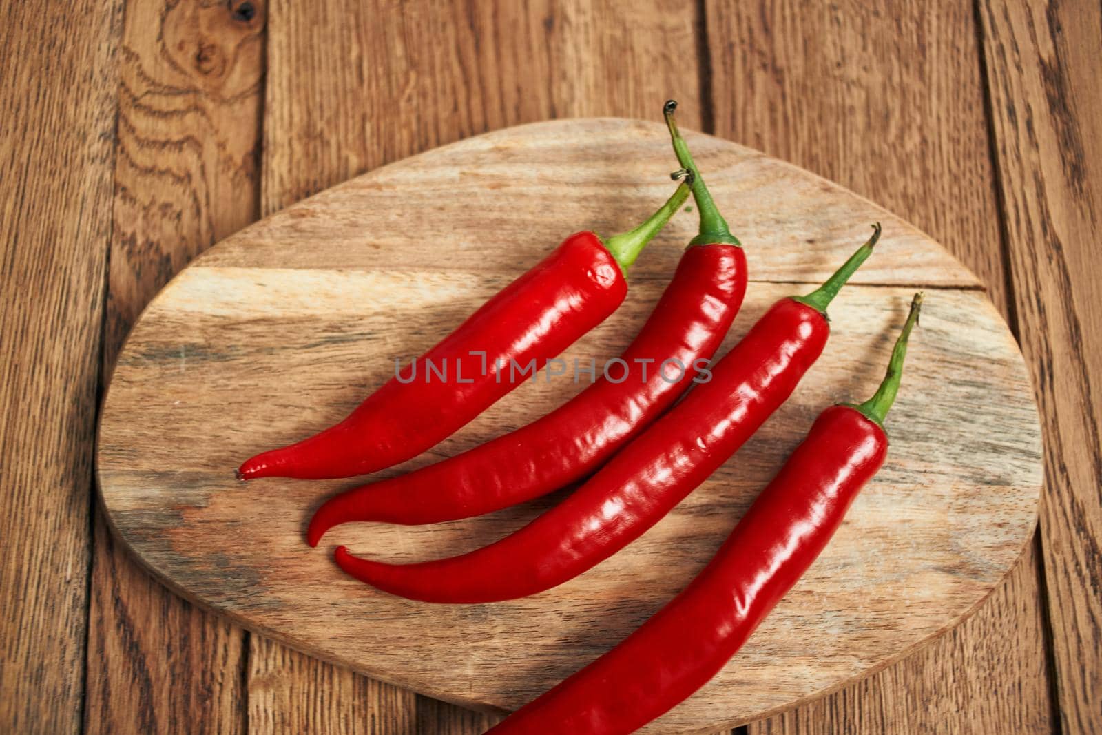 red hot chili peppers on a wooden board kitchen ingredients by Vichizh