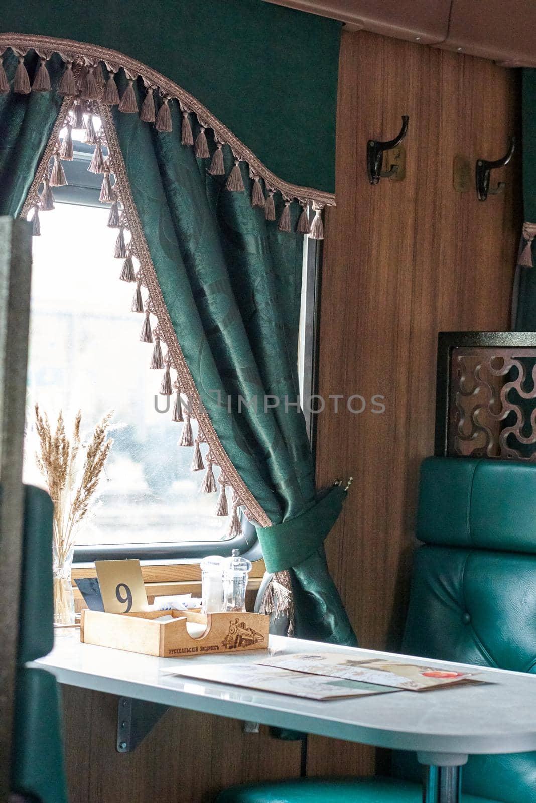 The interior of a steam-powered tourist retro train, stylized as Nikolaevskii Express and going along the route of Sortavala Ruskeala