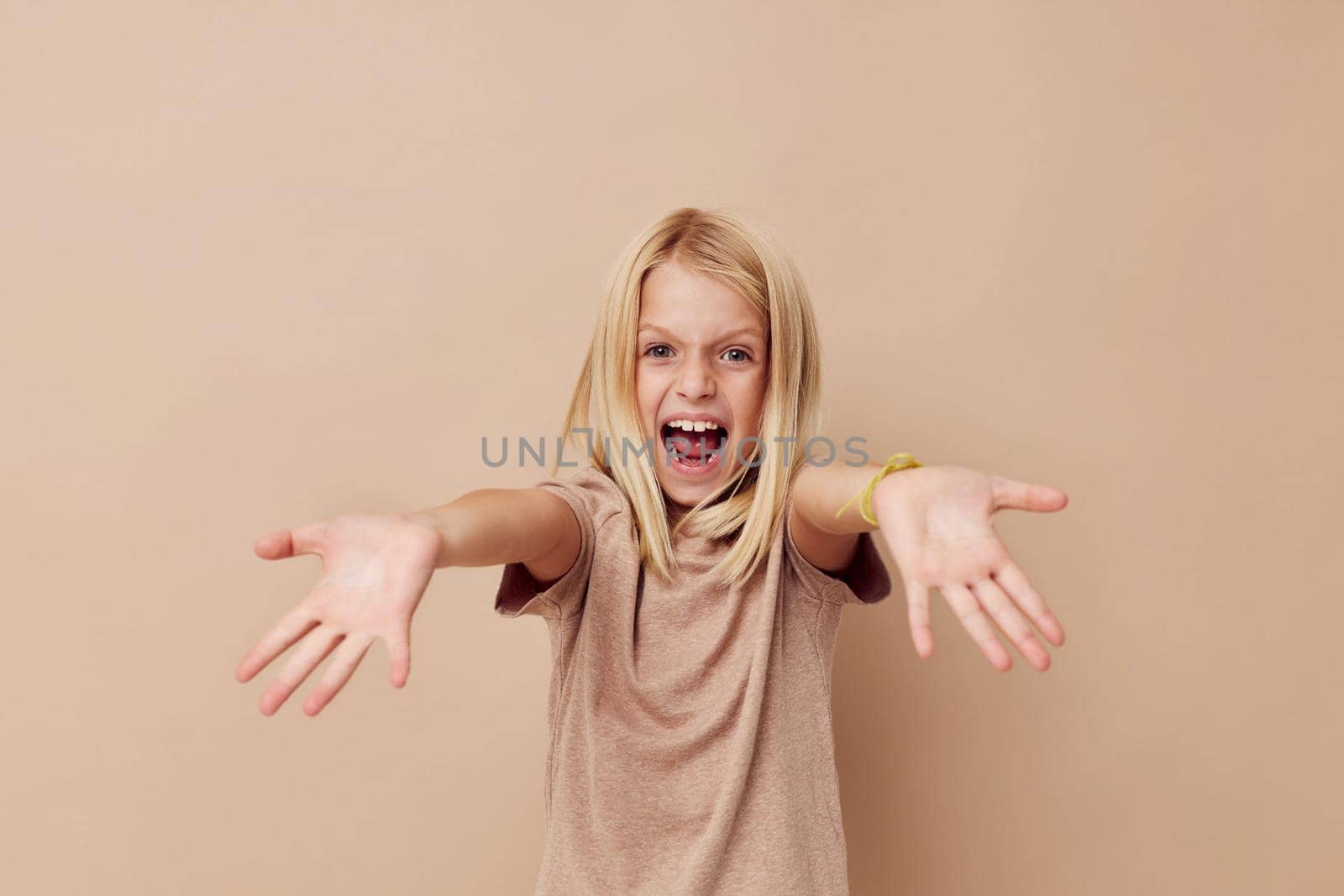 happy cute girl in a beige t-shirt isolated background. High quality photo