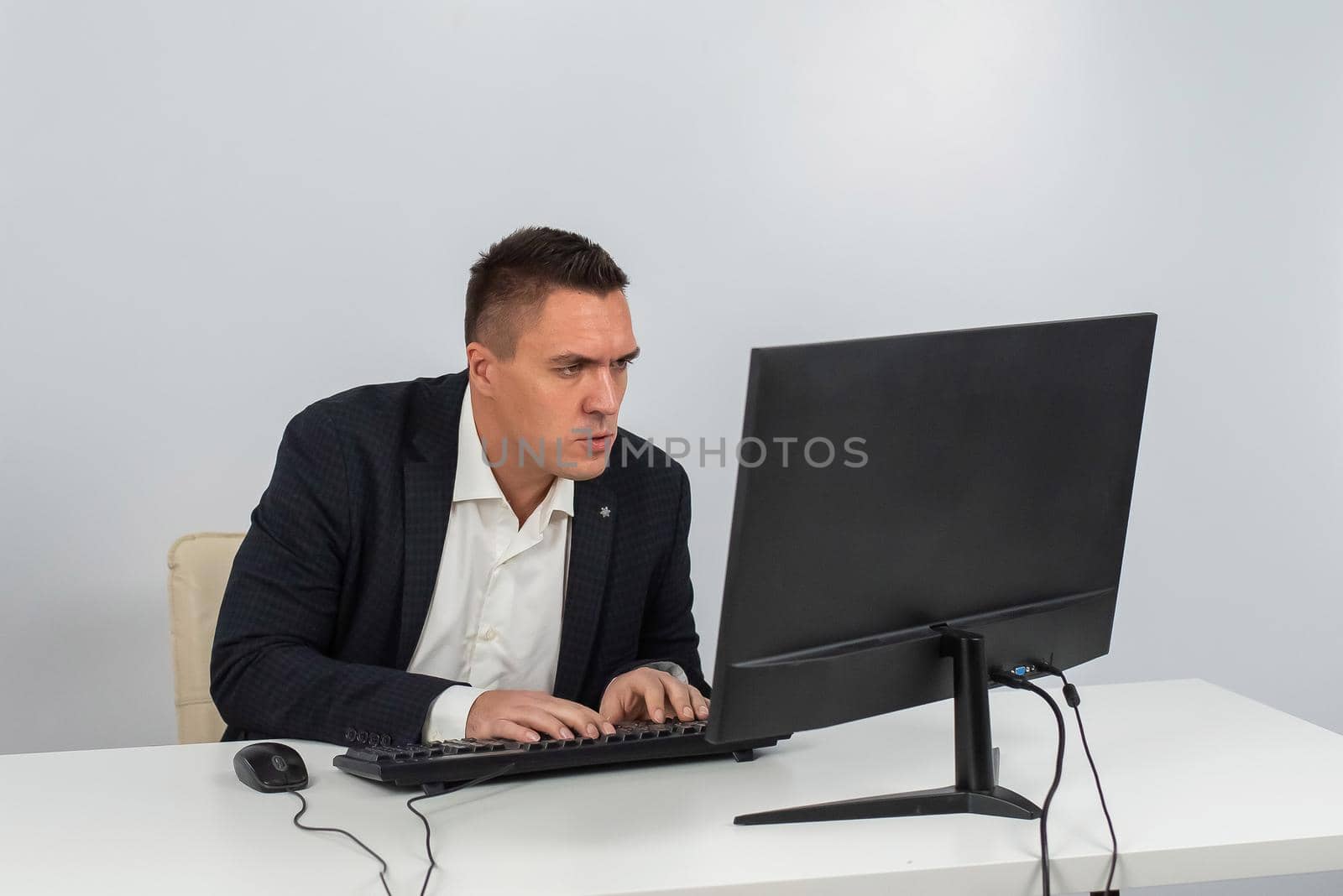 caucasian man working at the computer on a white background