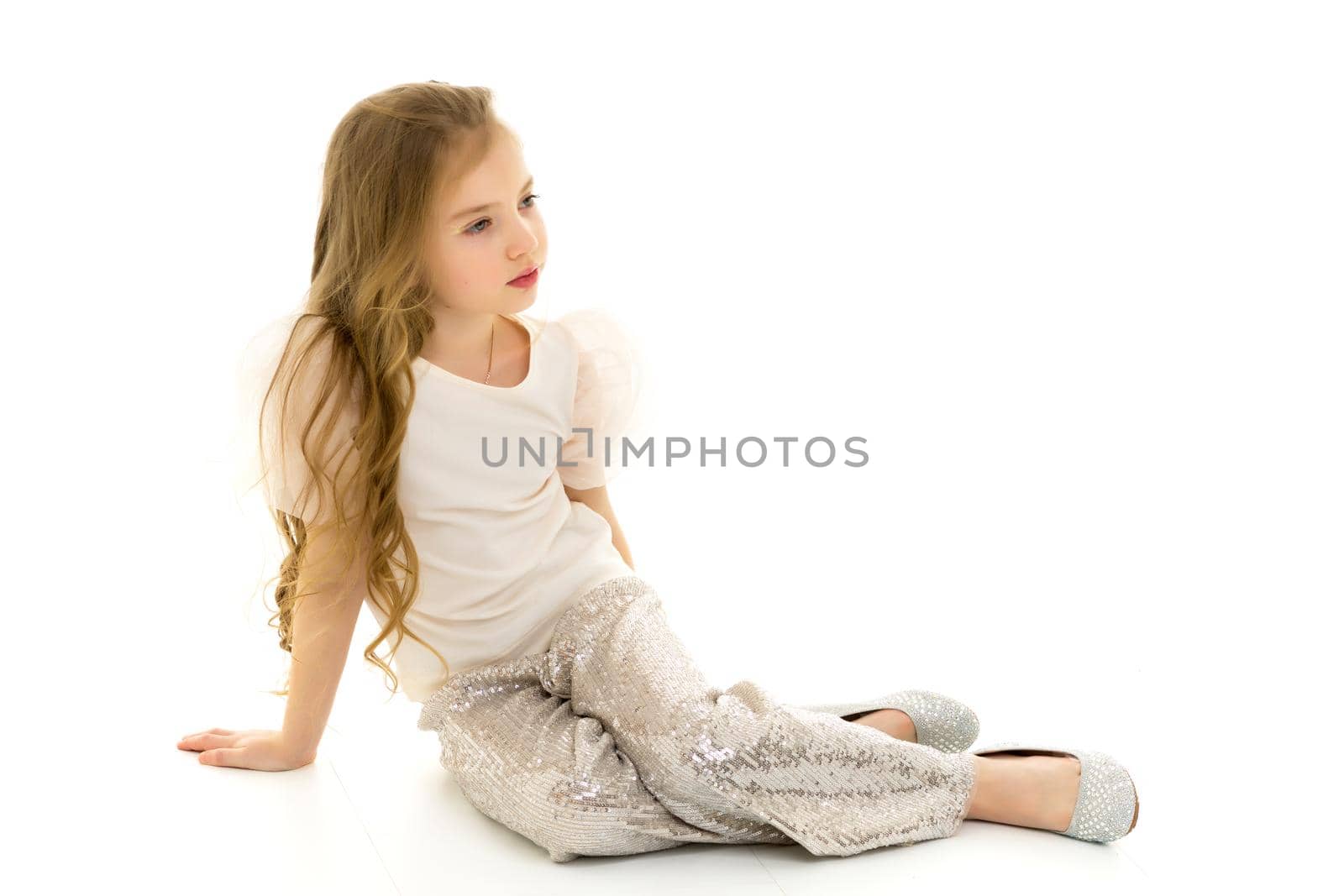 Little girl is sitting on the floor.The concept of a happy child by kolesnikov_studio