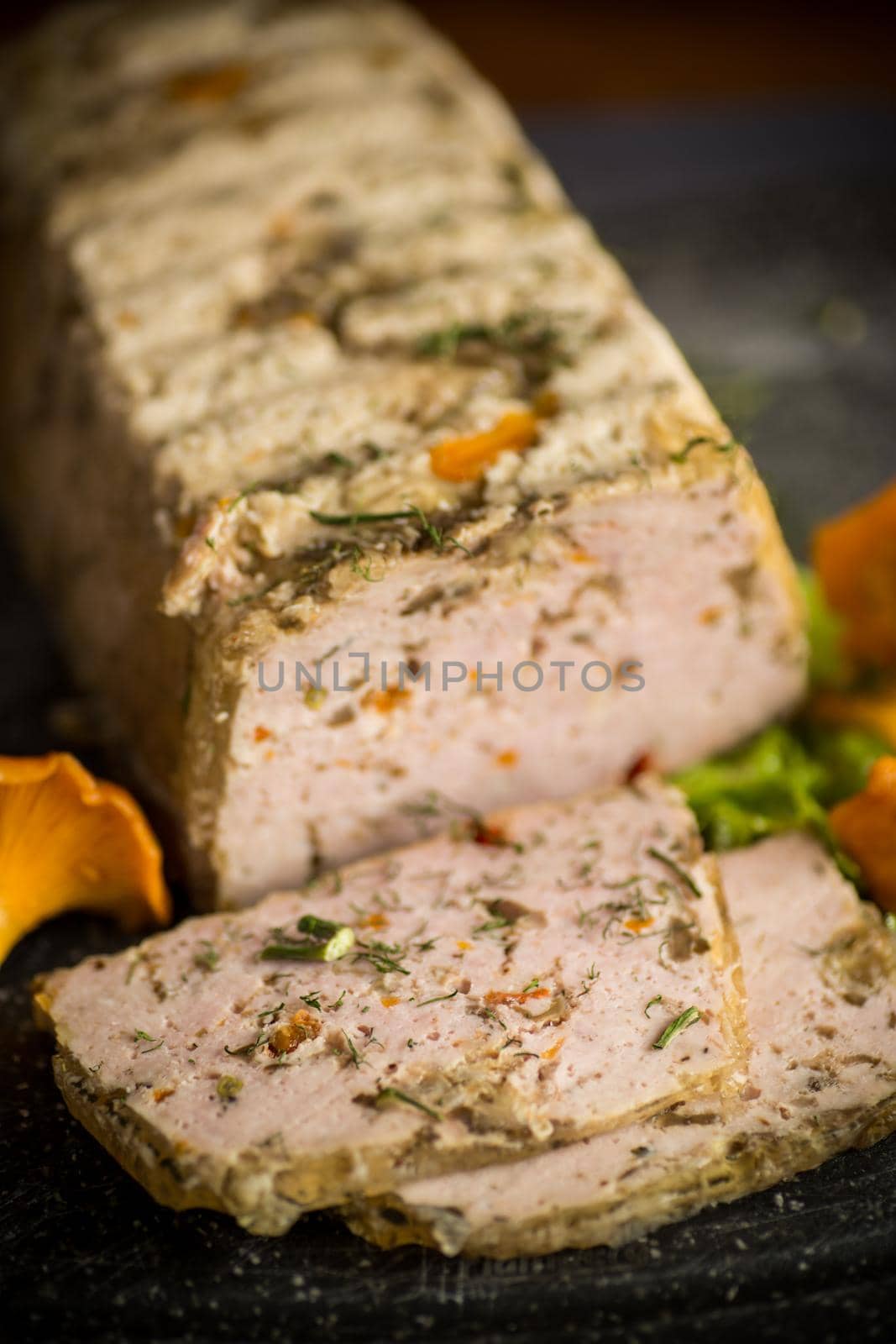 homemade sausage from minced meat with mushrooms and vegetables inside, on a wooden table