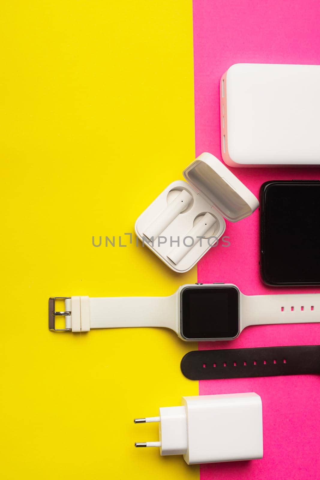 Layout of modern gadgets on a pink and yellow background . Online communication. Internet connection. Mobile communication. 5g. Black and white technology. Modern technologies. Copy space