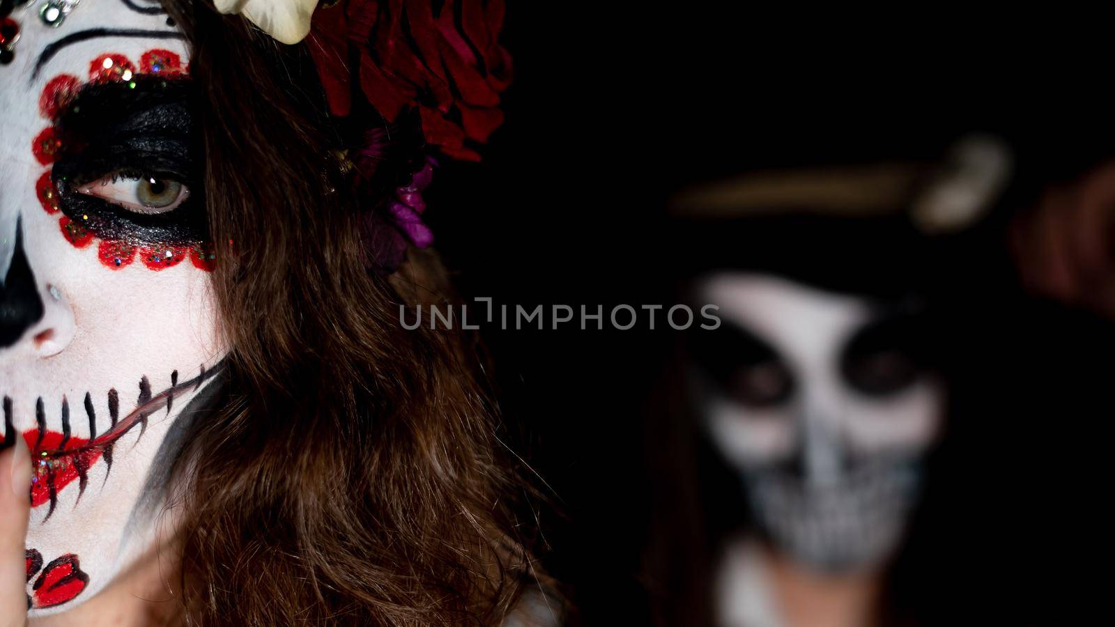 Woman in santa muerte costume and man in skeleton bodypainting for halloween. by mrwed54