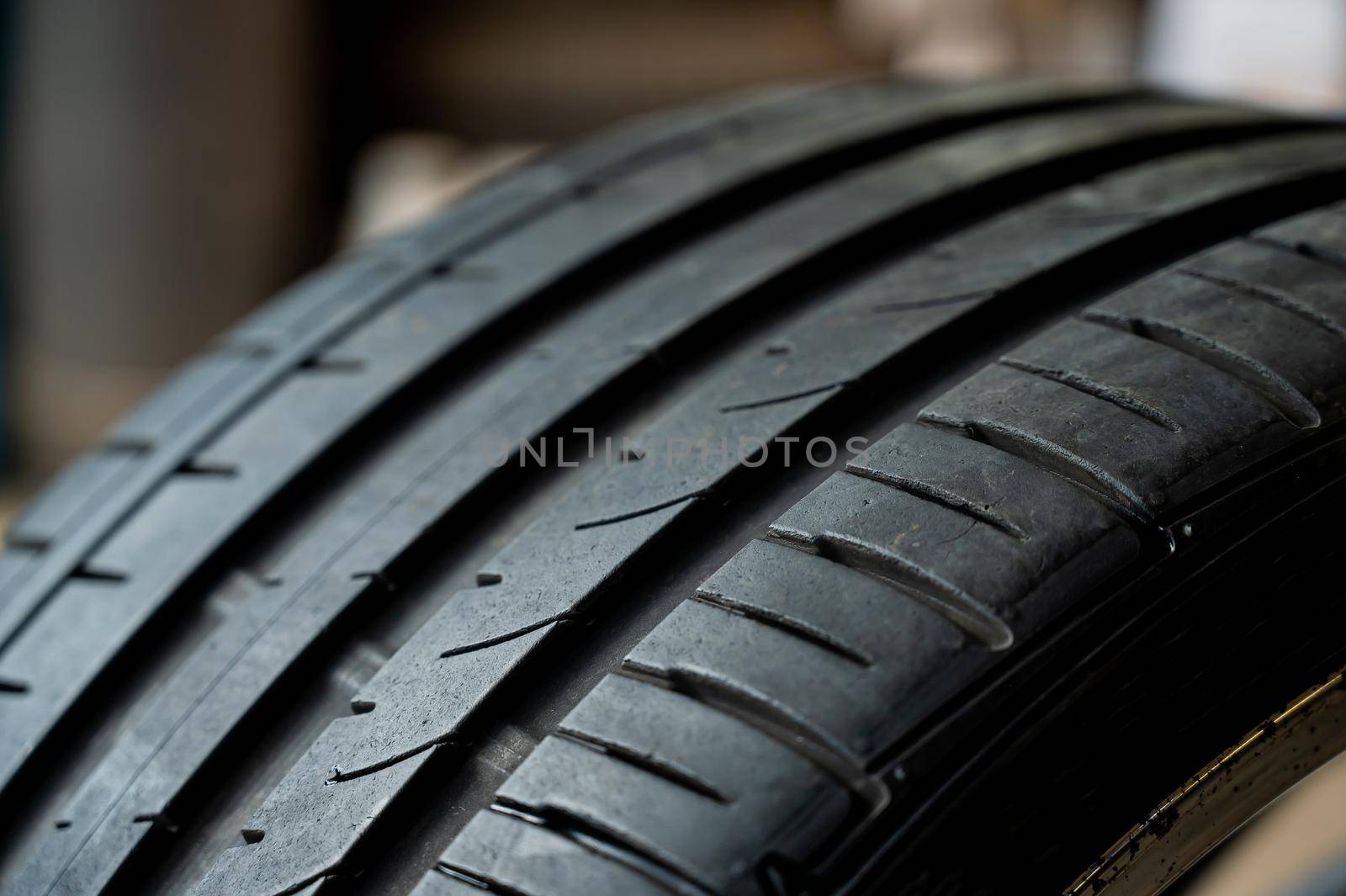Close-up of a new car tire with a tread. by mrwed54