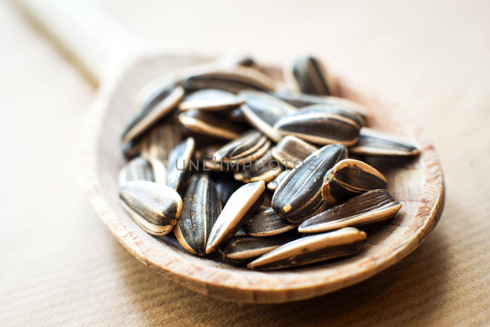 sunflower seeds in a wooden spoon