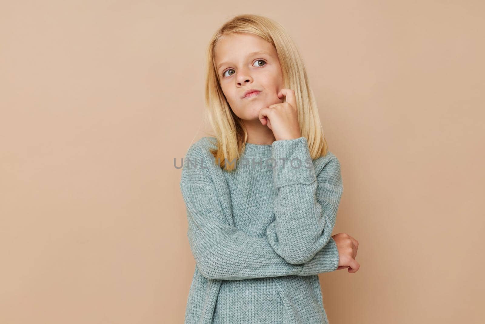 Positive little girl with blond hair kids lifestyle concept. High quality photo