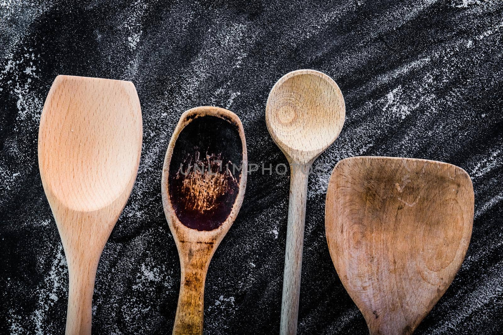 wooden spoons on a black textured table