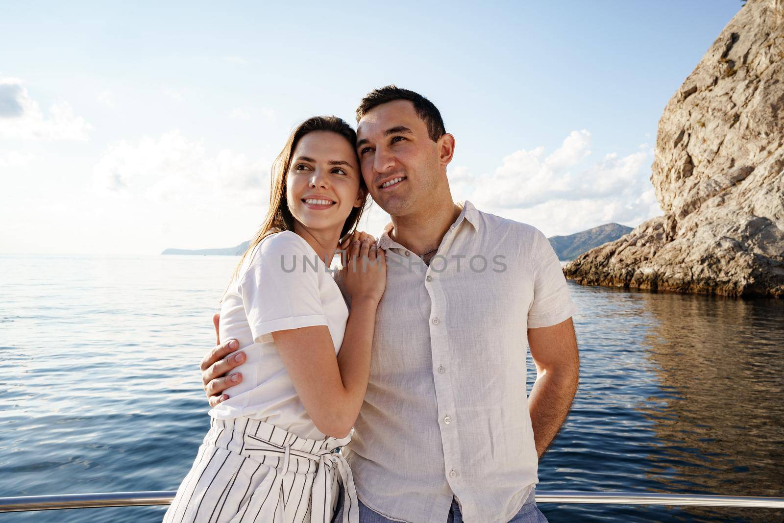 Happy couple in love on a yacht in summer on romantic vacation