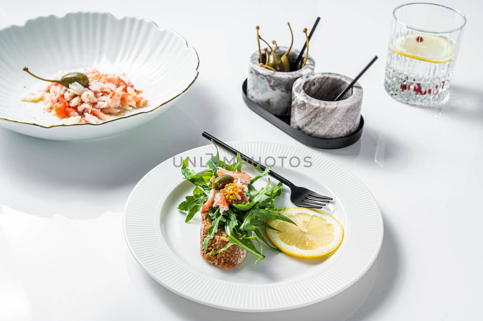 Salad with Crab meat on a kitchen table. White background. Top view.