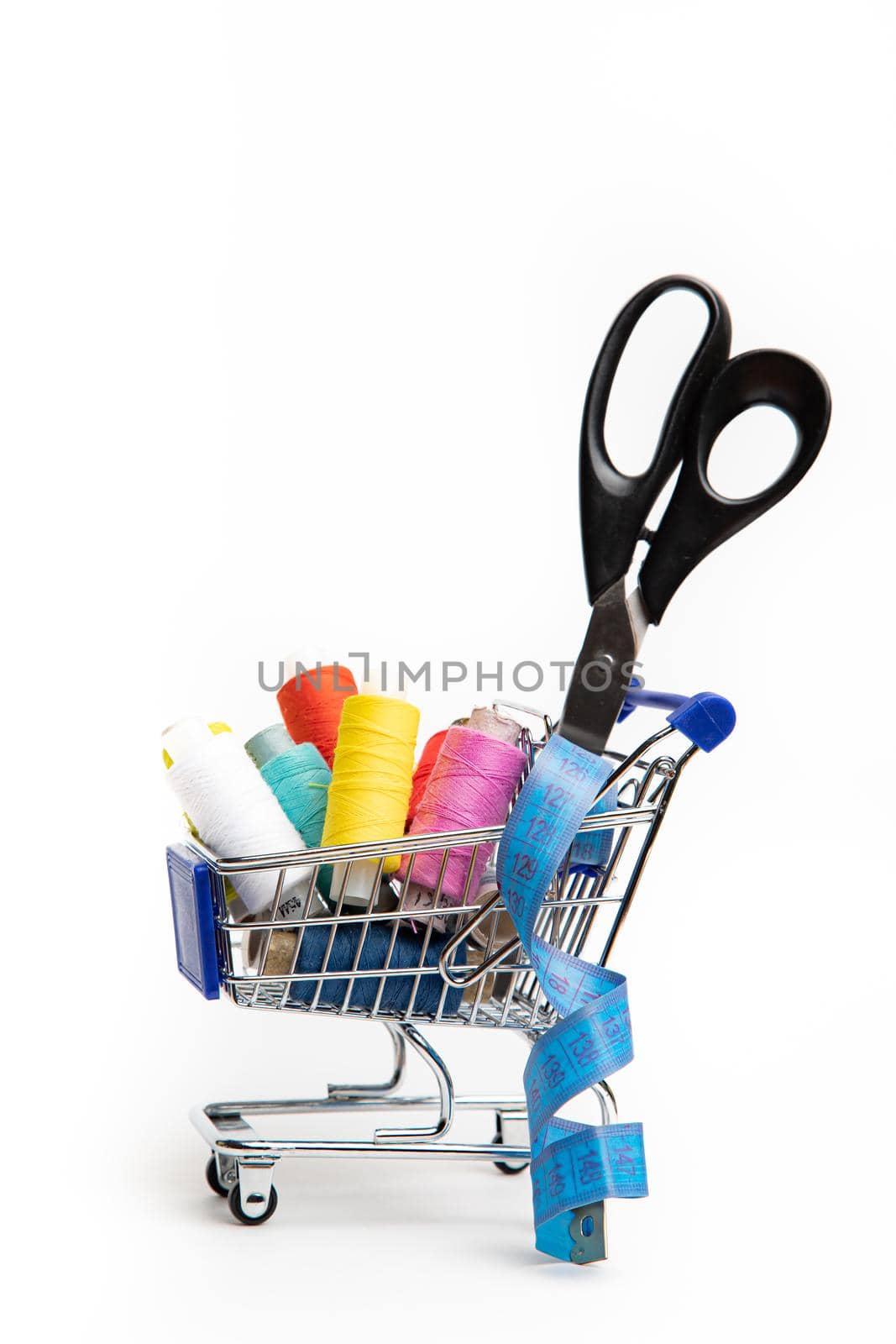 Trolley with thread on a white background . Thread selection. Shopping for needlework. White background. Copy space