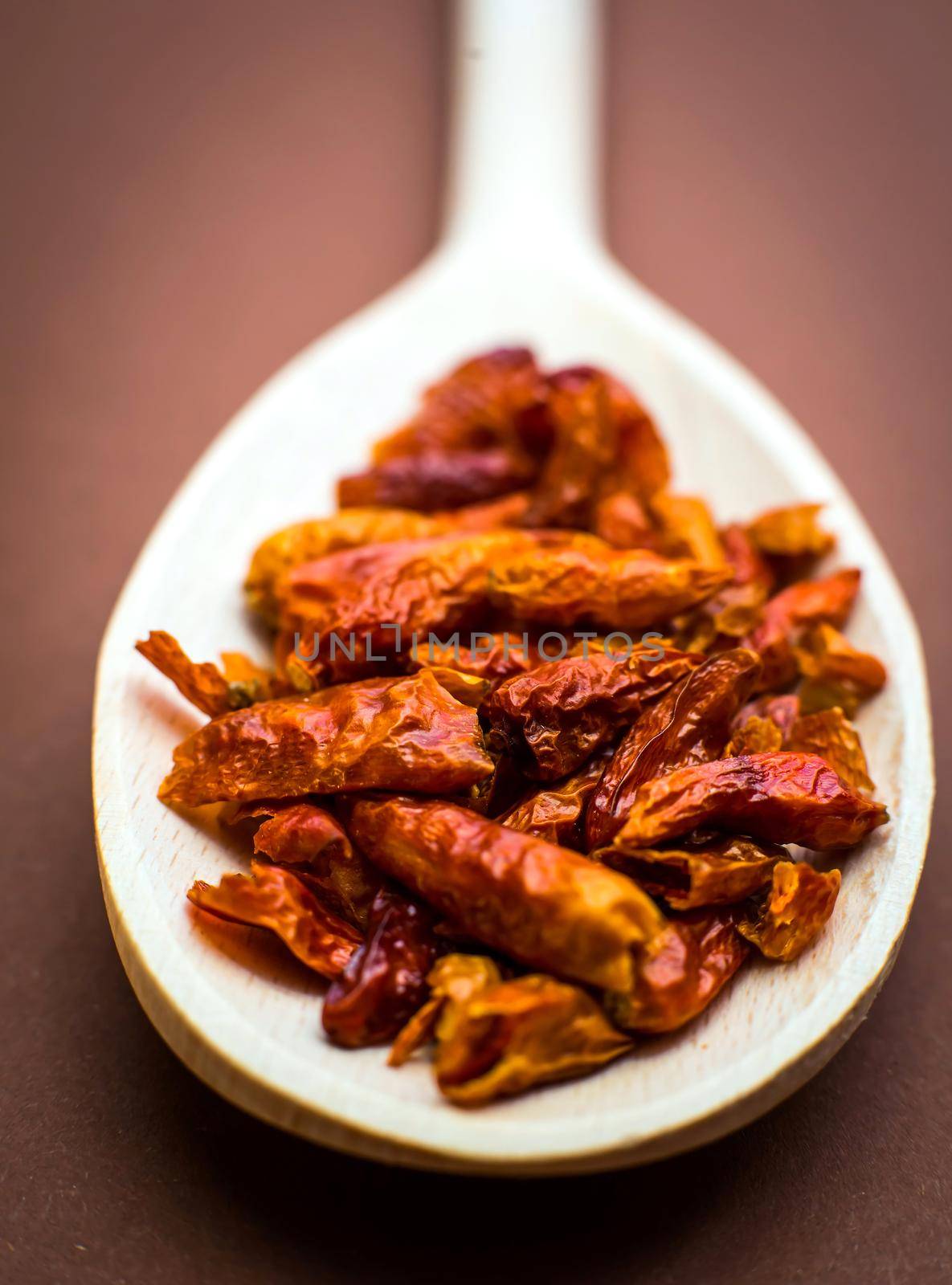 Lot of dried chili in wooden spoon