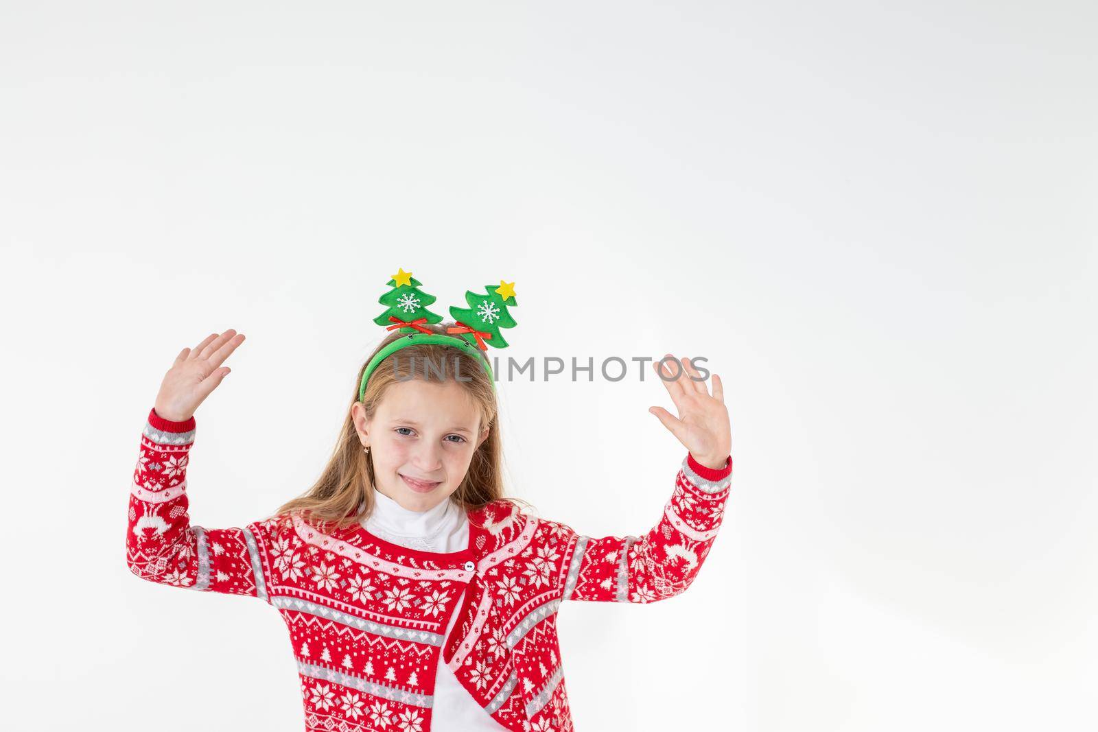 Portrait of excited funny funky schoolchild dancing in christmas costume with headband isolated on white background.Ready For Christmas party.Merry Christmas presents shopping sale concept. by YuliaYaspe1979