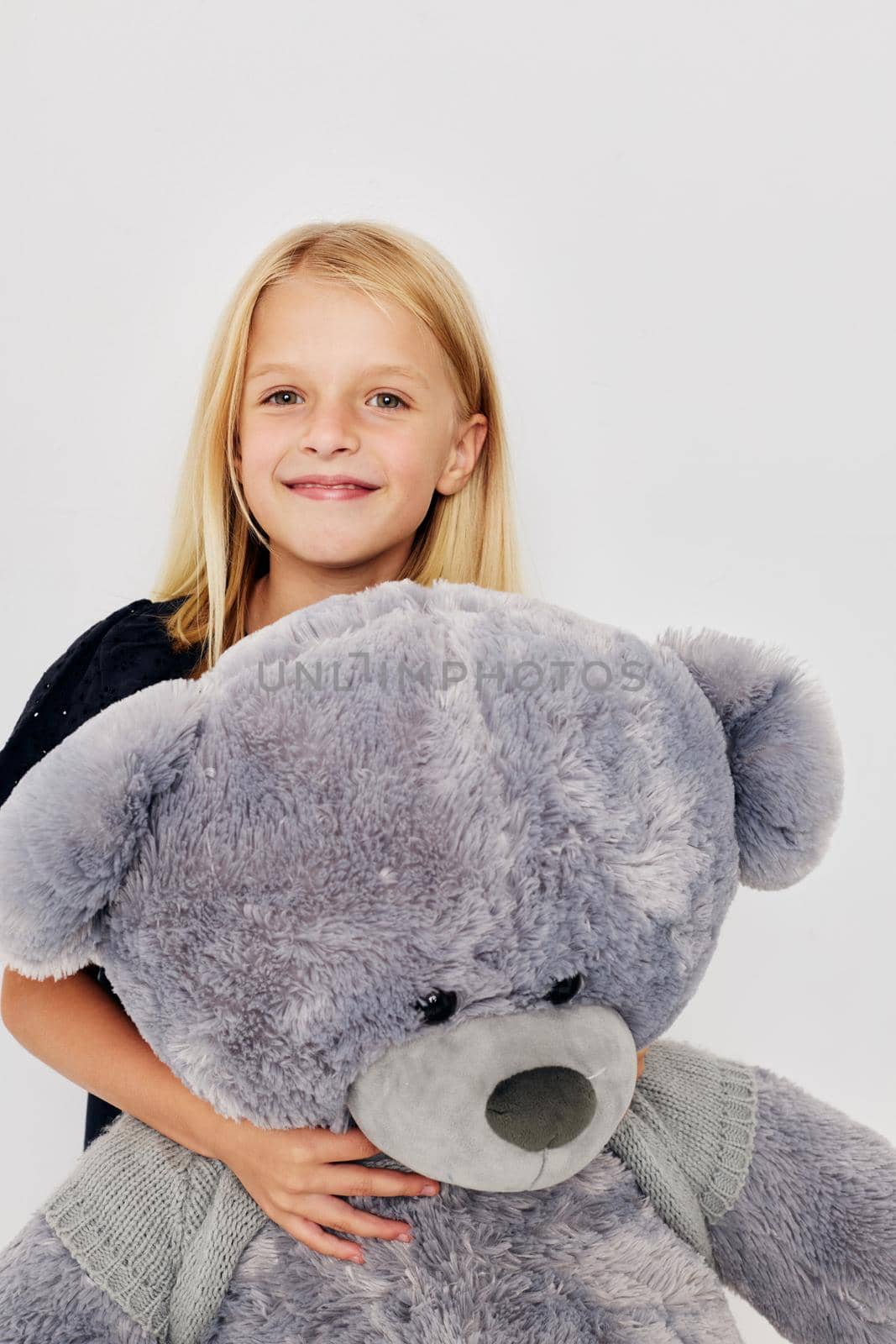 Portrait of a smiling little cutie teddy bear in the hands of fun isolated background. High quality photo