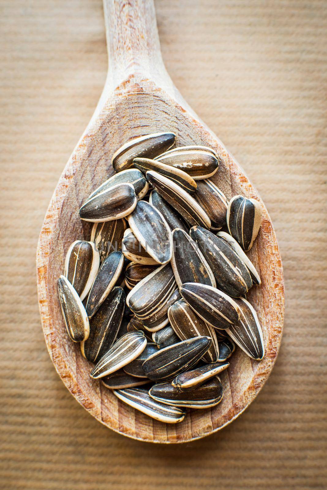 sunflower seeds in a wooden spoon