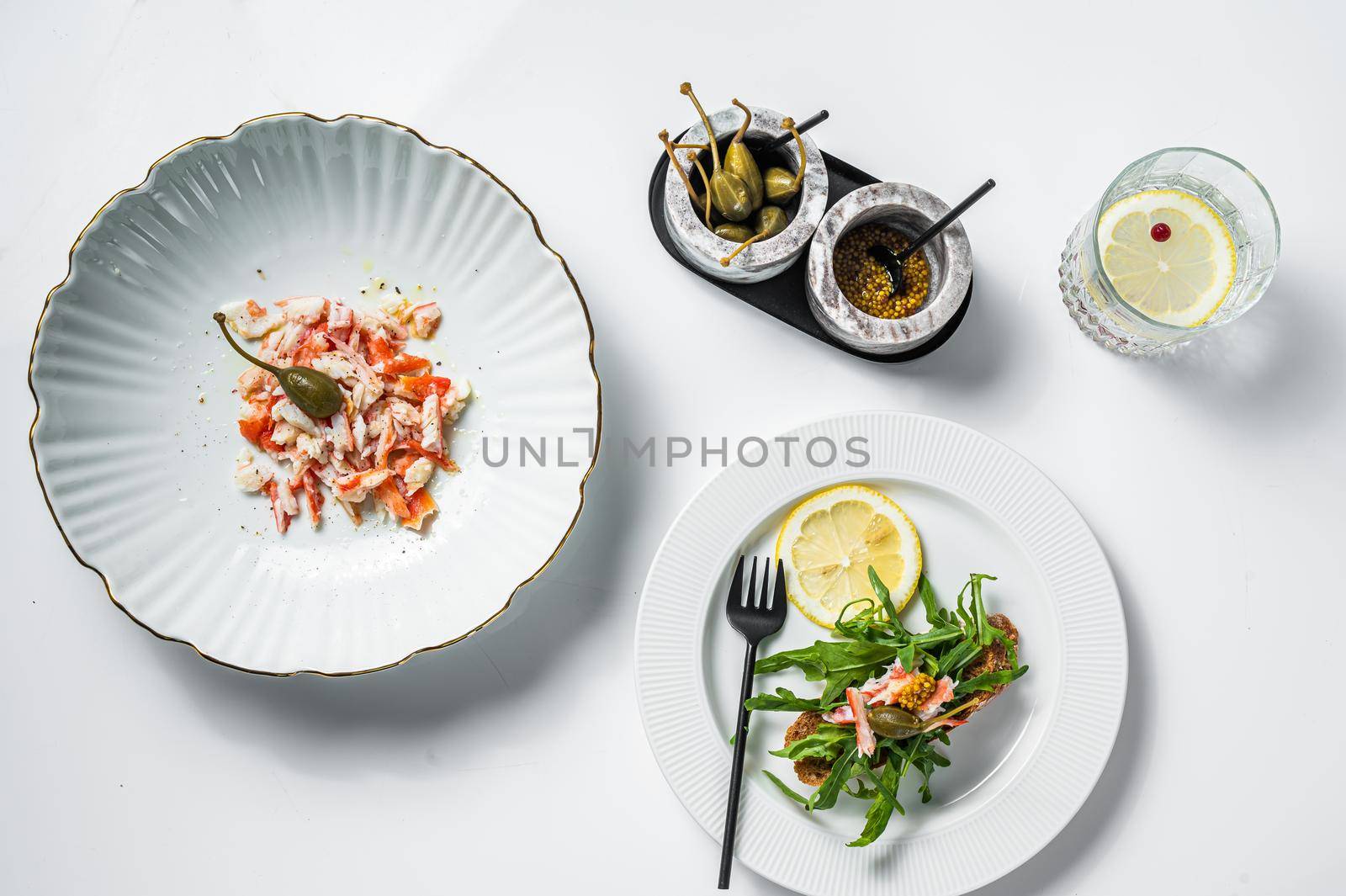 Salad with Crab meat on a kitchen table. White background. Top view.
