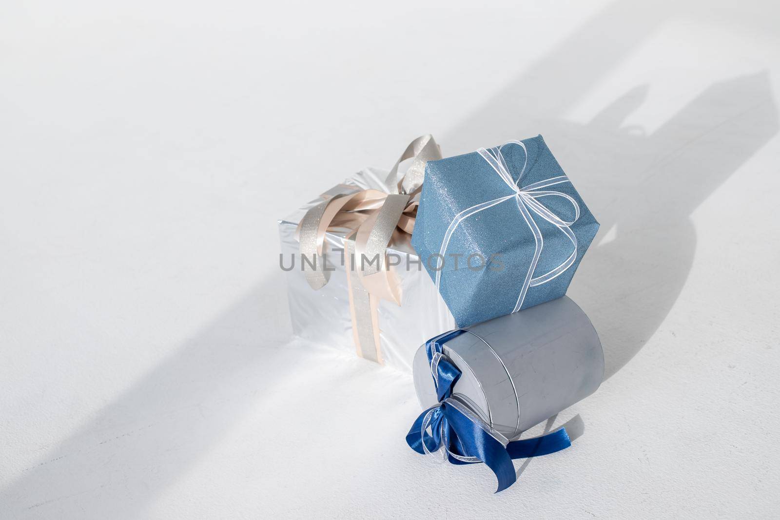 Decorative Christmas gifts on white background.blue and silver stylish christmas gifts. morning family waiting for eve. Happy new year presents. celebration concept by YuliaYaspe1979