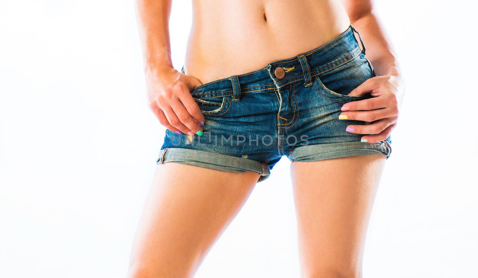 Figure of sexy young women in blue denim shorts isolated on a white background