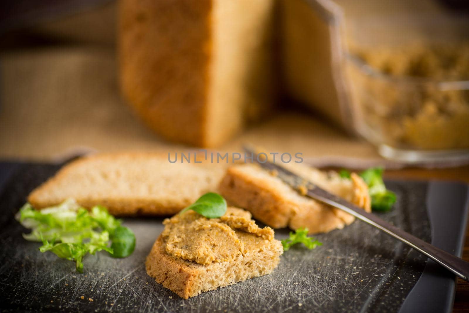 homemade meat pate with homemade bread on a wooden table