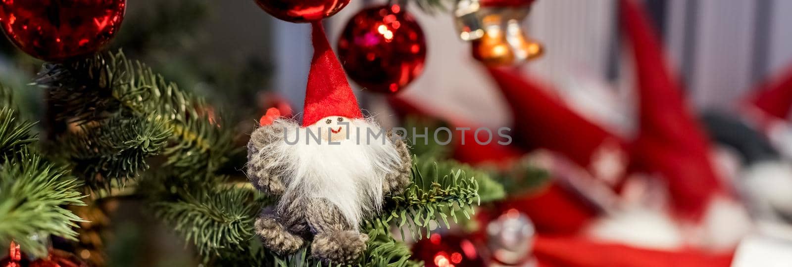Christmas tree with colorful toys in the interior. Traditional christmas tree Panoramic web banner size. Selective focus.Winter festive concept. New Year decor with vintage ornaments.Copy space by YuliaYaspe1979