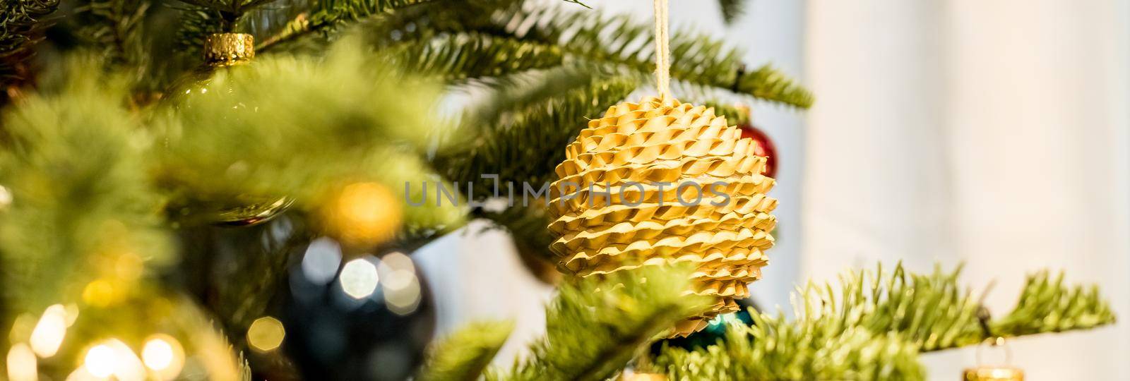 Christmas tree and decorations,eco, sparking, glowing balls. Happy New Year. Red and golden balls and illuminated garland with flashlights. New Year baubles on branch. Winter holiday. Web banner by YuliaYaspe1979