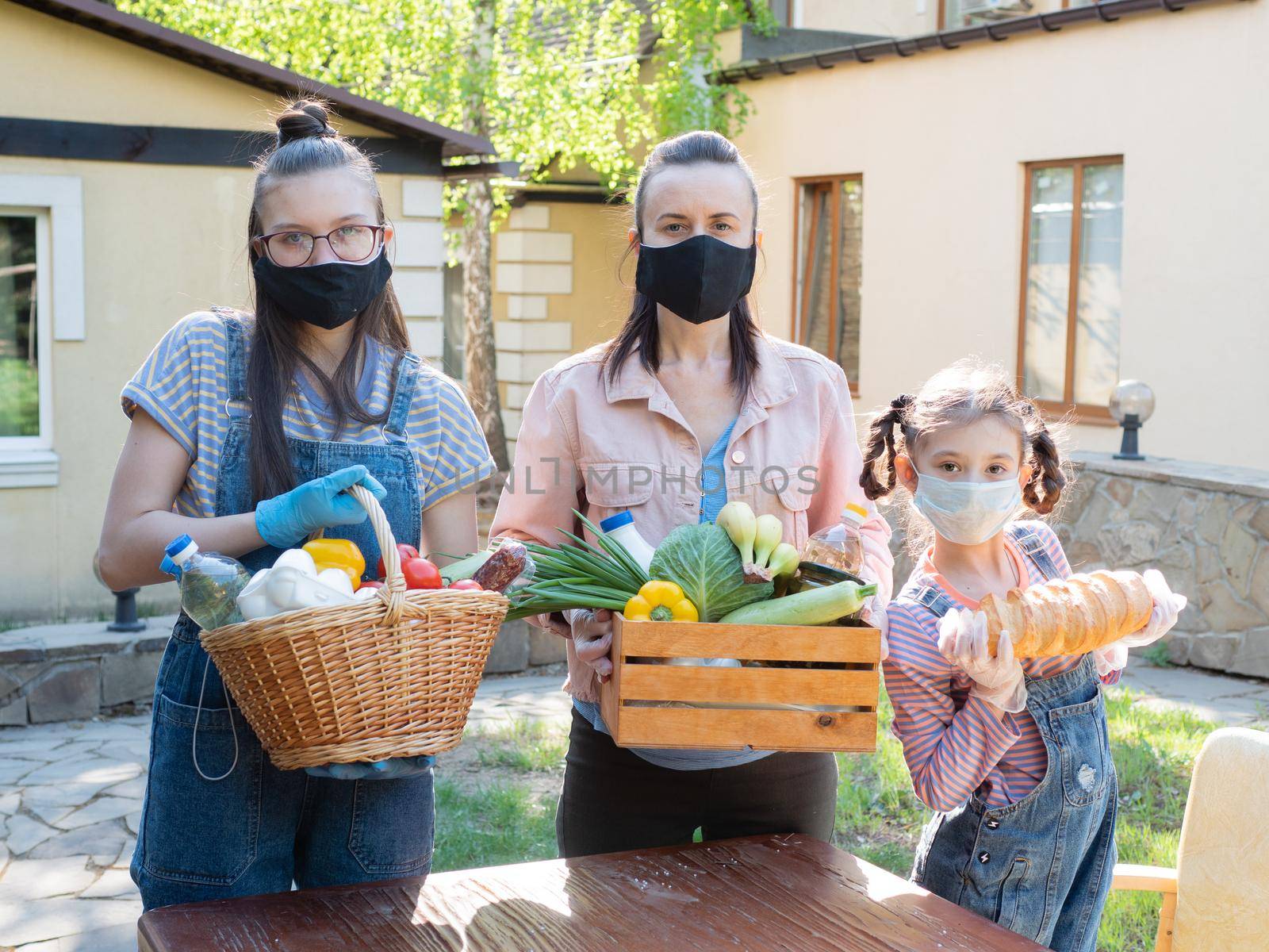 A family of volunteers with food packages for those in need. by Utlanov