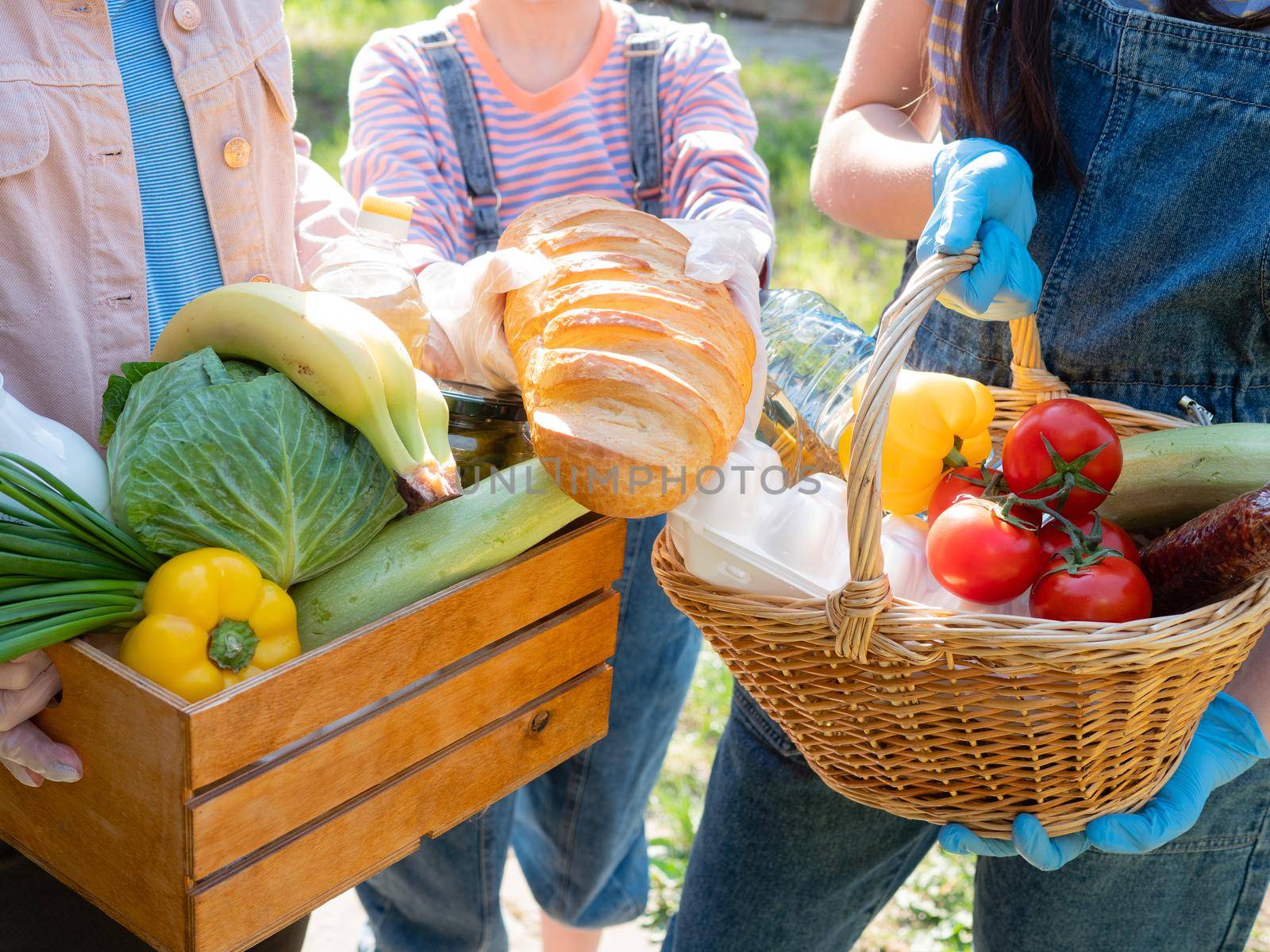 Food package for the needy in the period of the pandemic coronavirus in the hands of volunteers. Close-up of food packages for the poor. by Utlanov