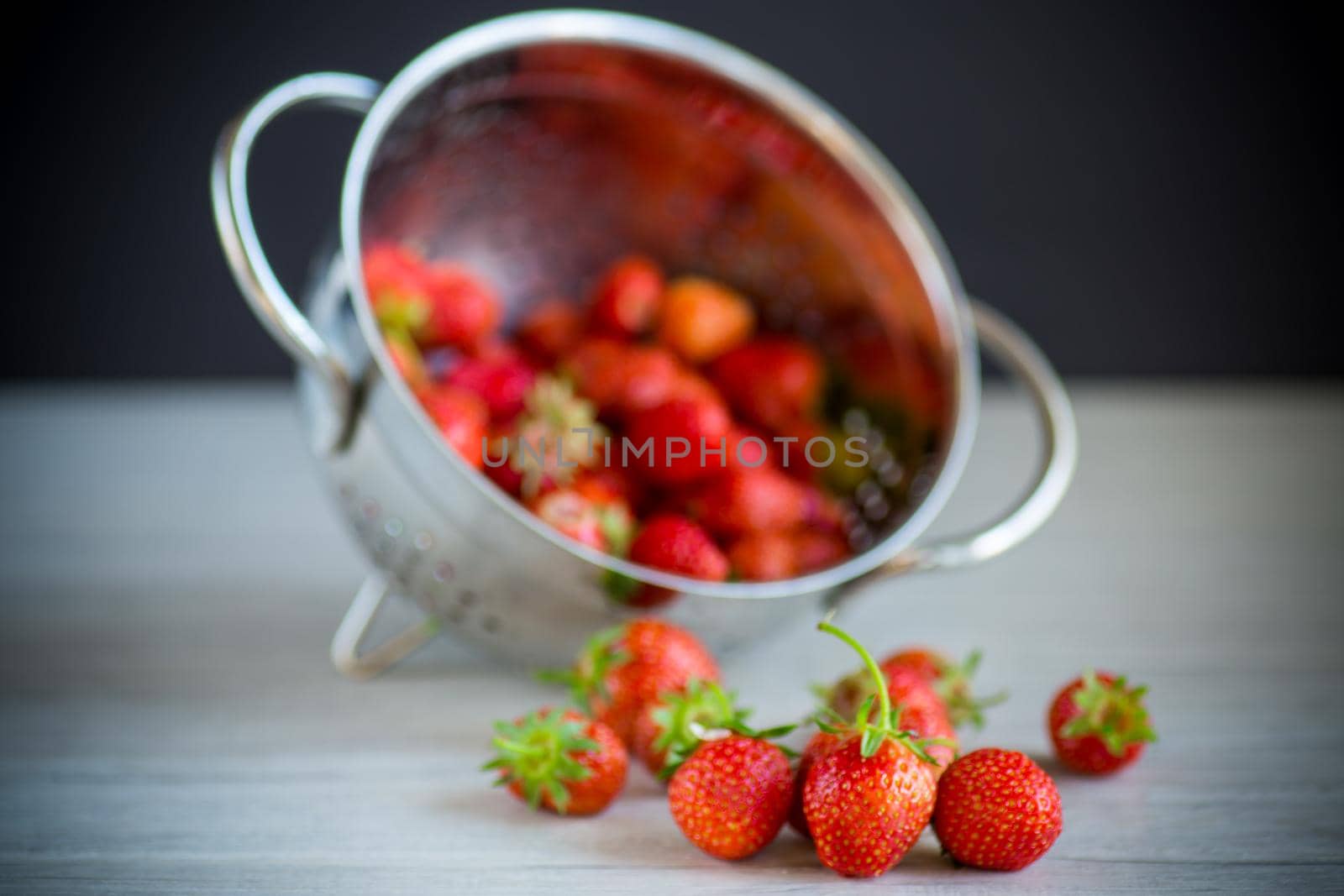 harvest of red ripe natural strawberries on a wooden table