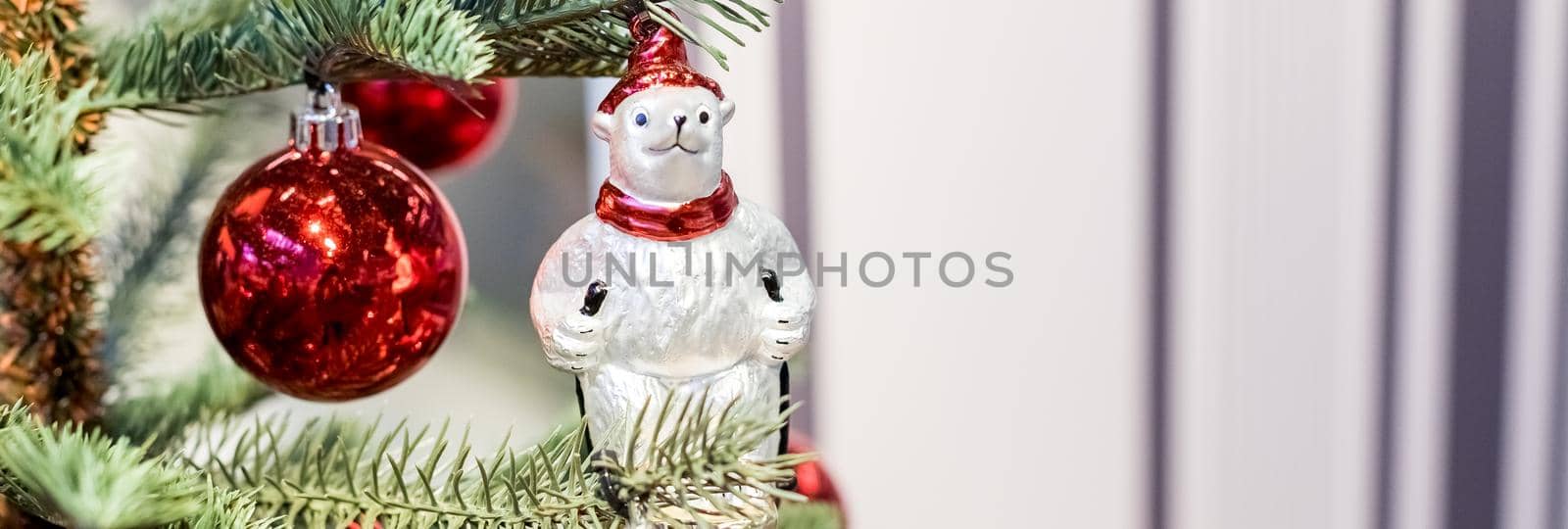 Christmas tree with red purple and white toys and flowers in the interior. Traditional christmas tree