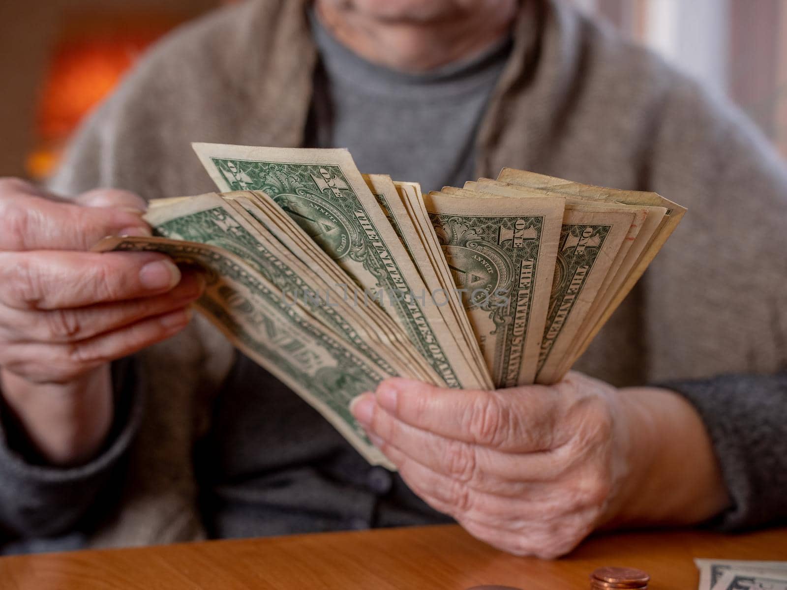An elderly woman counts the remaining money. Economic crisis, poverty of the elderly. by Utlanov