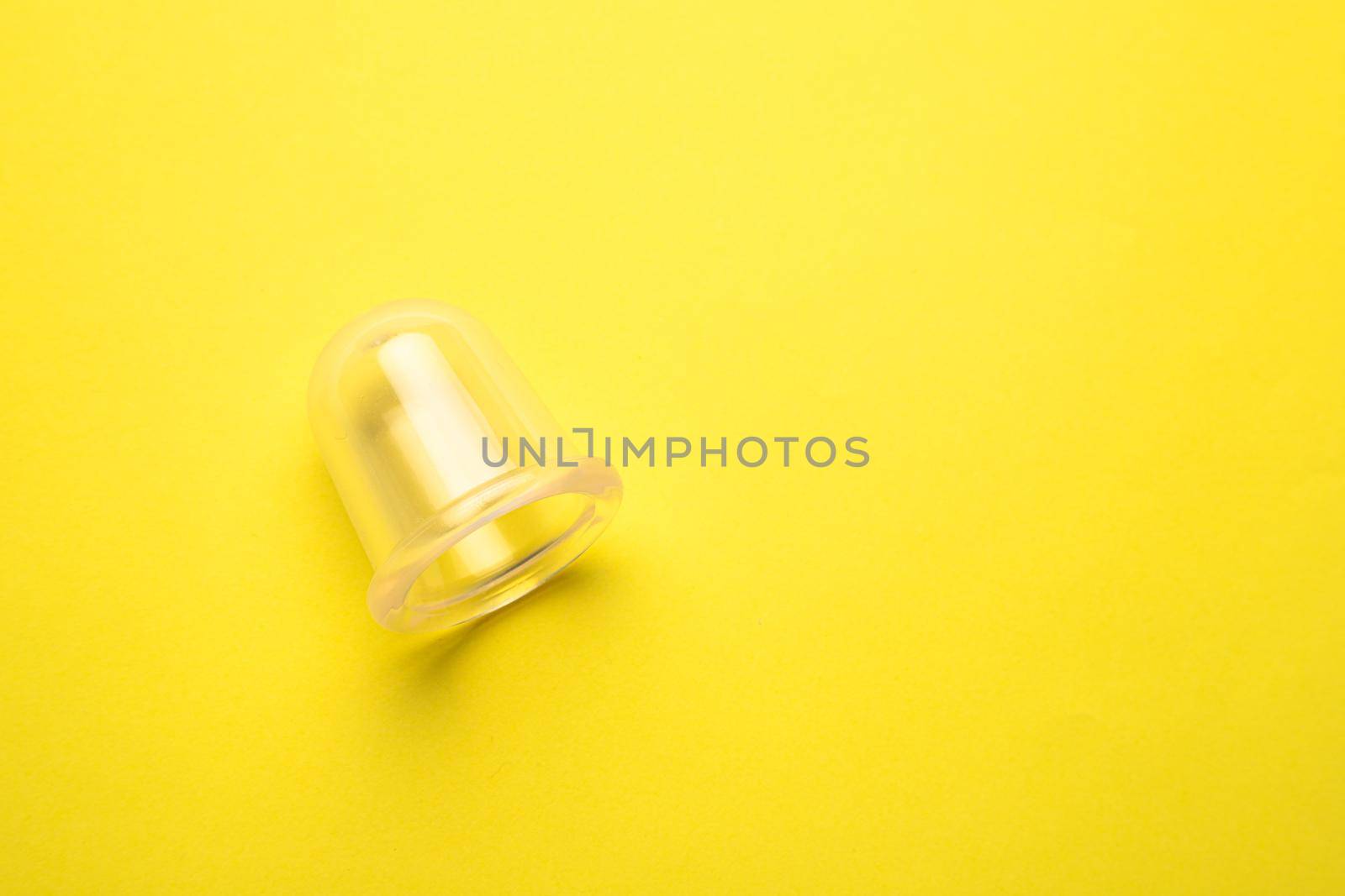 vacuum body massager on a yellow background copy device. an article about massage. how to remove cellulite