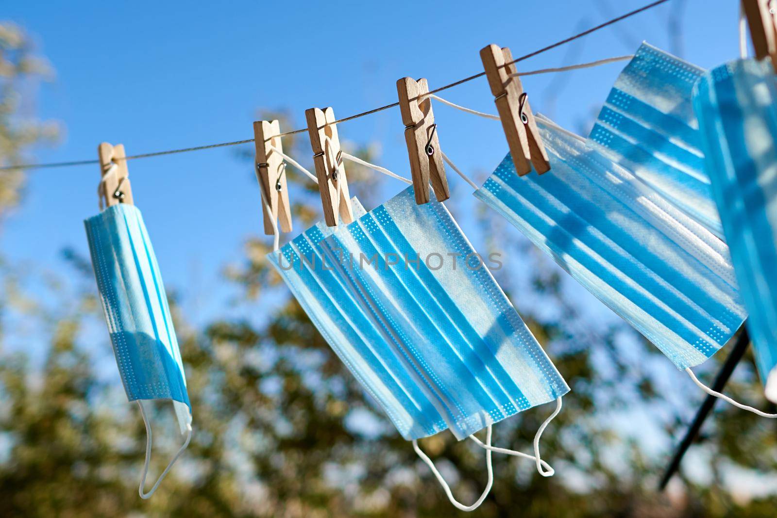Sunlit face masks are hung to dry for disinfection. New normal concept