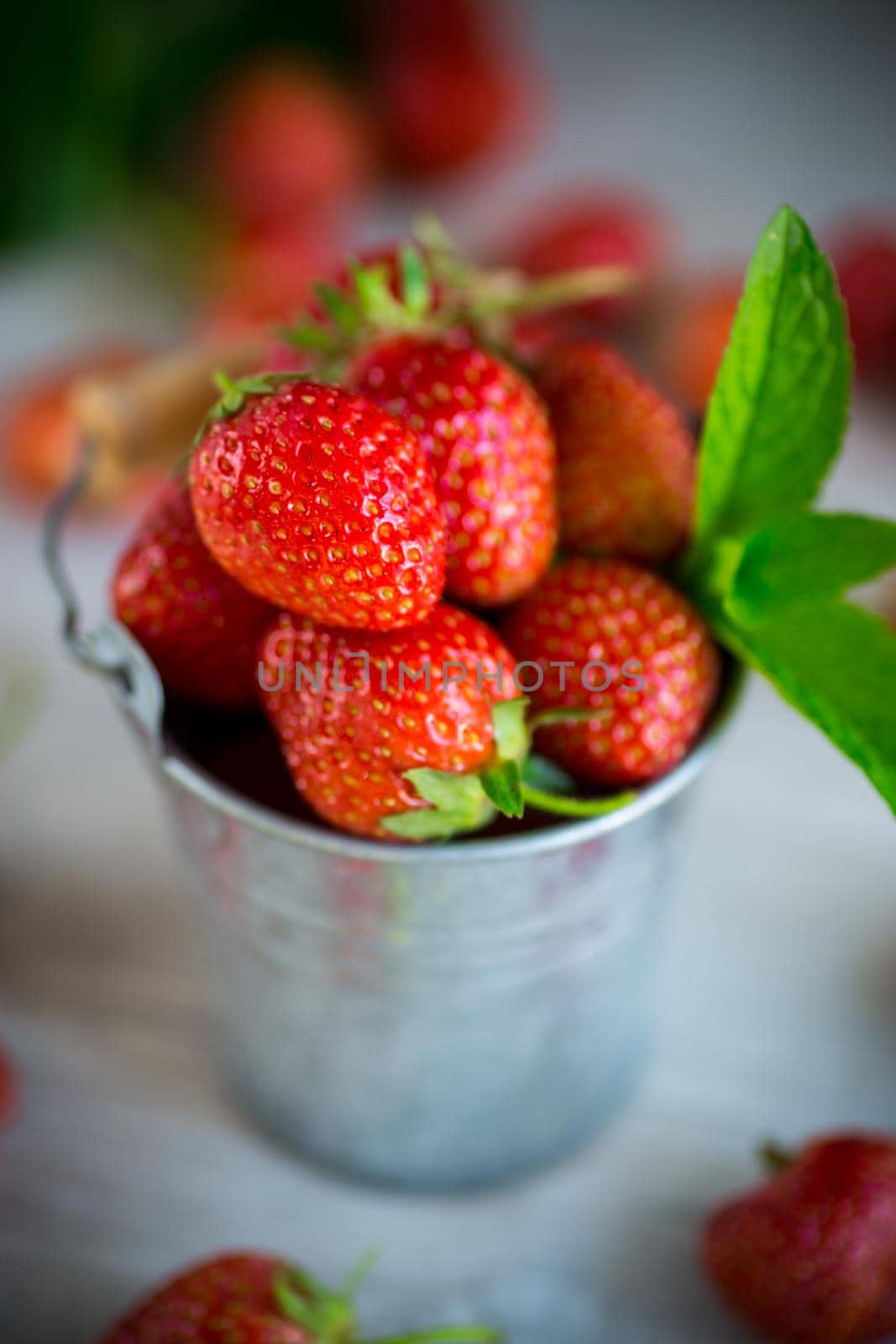 harvest of red ripe natural strawberries on a wooden table