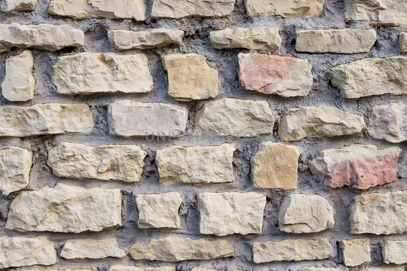 Background of stone wall texture.Ancient wall built of white stone