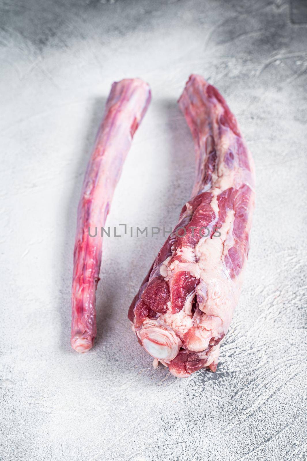 Raw whole Beef veal Oxtail Meat on butcher table. White background. Top view.