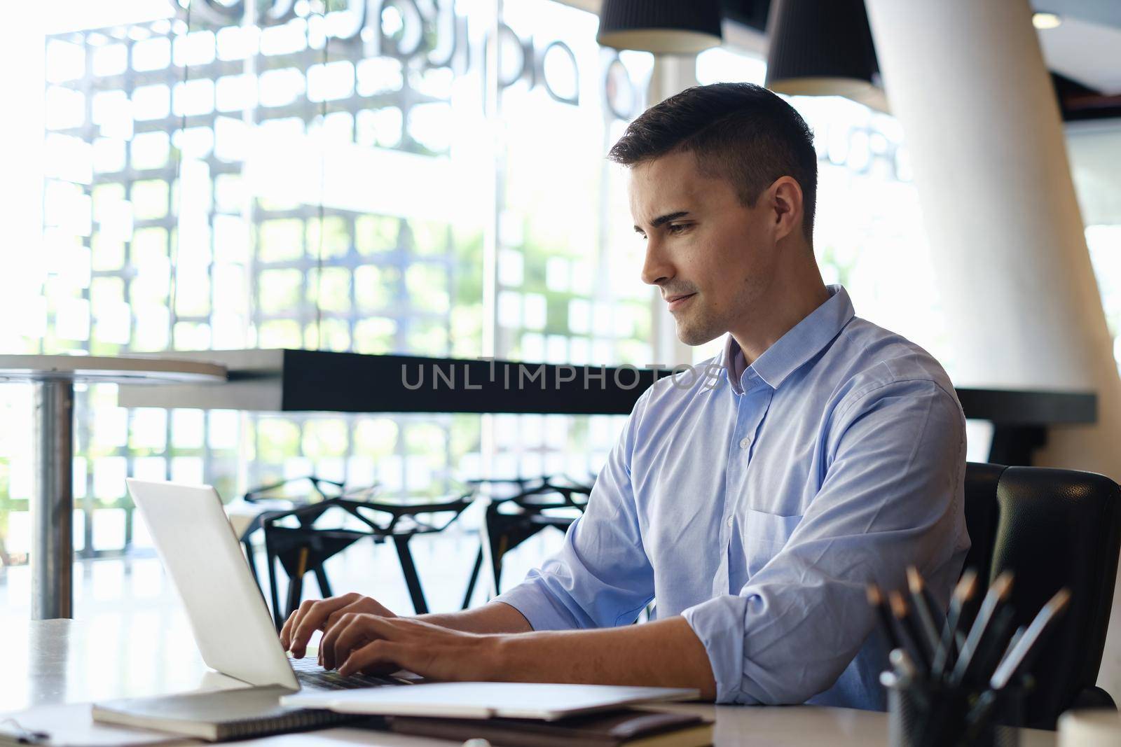 Businessman working and video call by laptop in home office. Business financial concept. by itchaznong