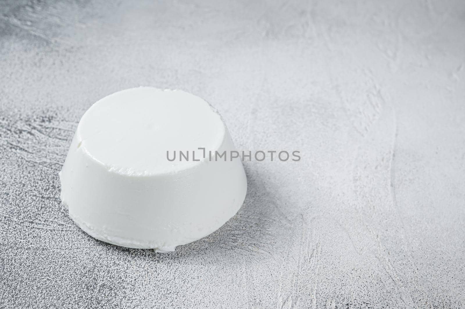 Ricotta cream Cheese on kitchen table. White background. Top view. Copy space by Composter