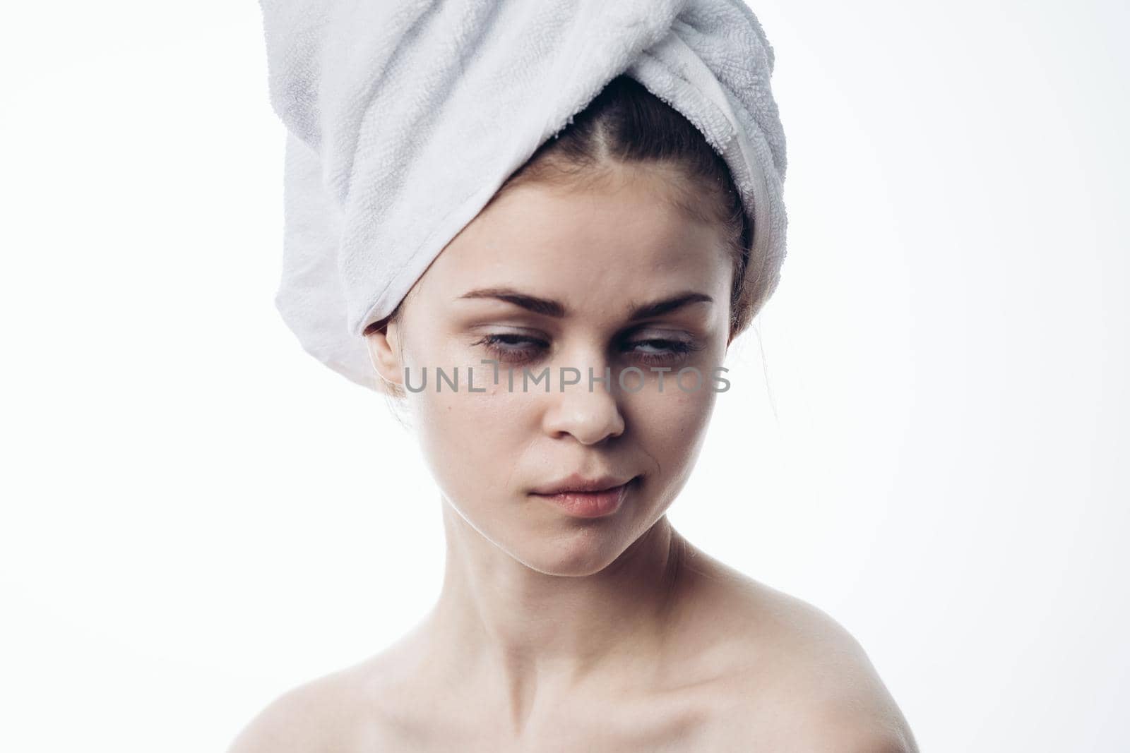 woman after shower with towel on head posing skin care by Vichizh