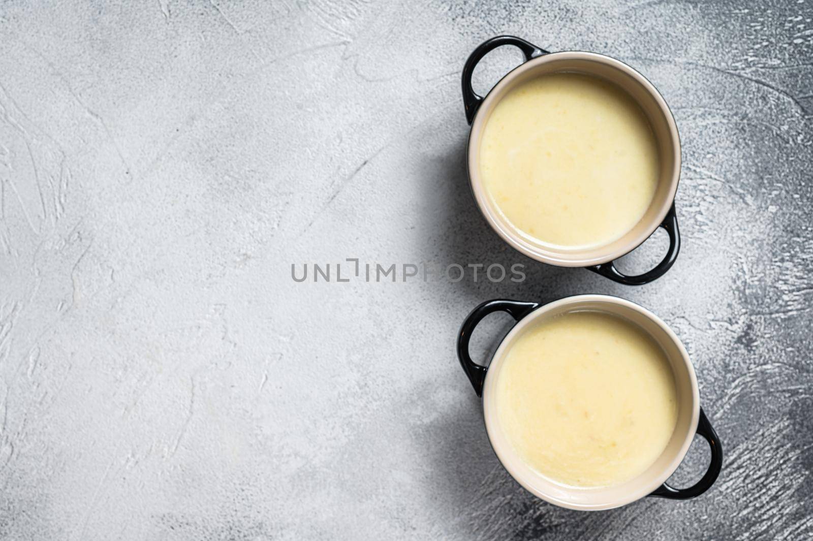 Homemade potato cream soup in bowls. White background. Top view. Copy space.