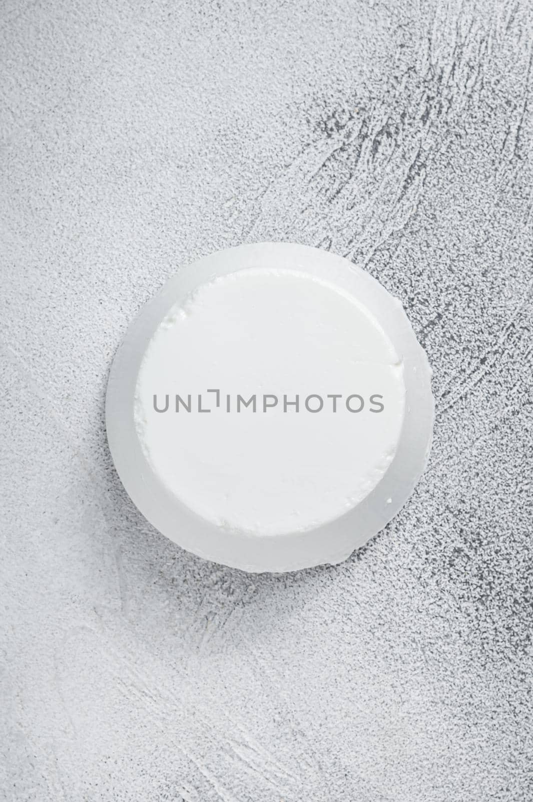 Ricotta cream Cheese on kitchen table. White background. Top view.