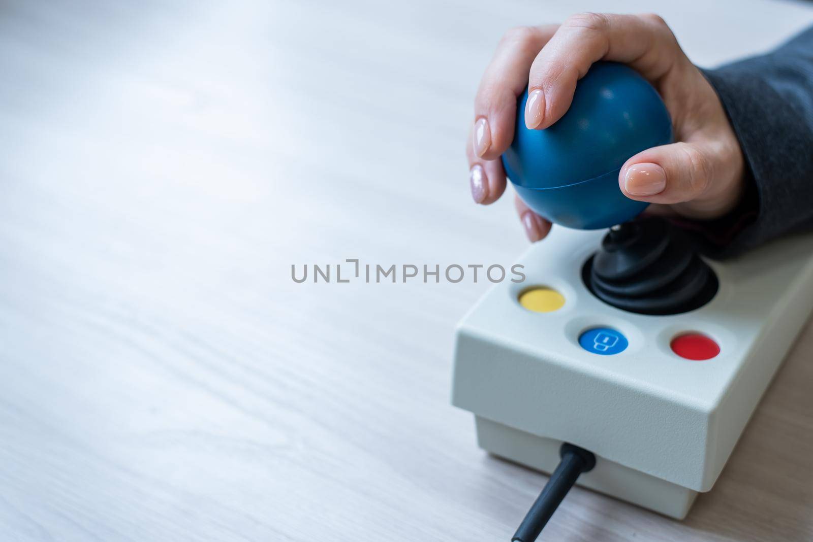 Woman with cerebral palsy works on a specialized computer mouse. by mrwed54