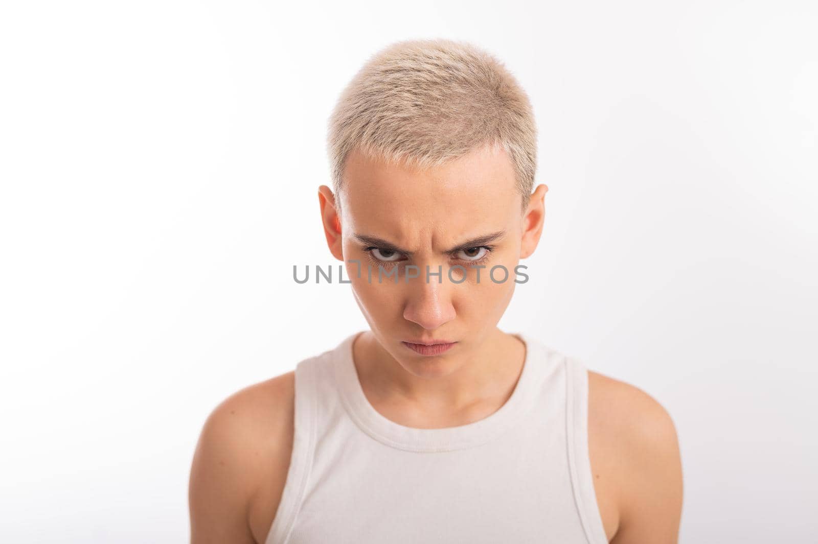 Displeased young caucasian woman with short haircut on white background