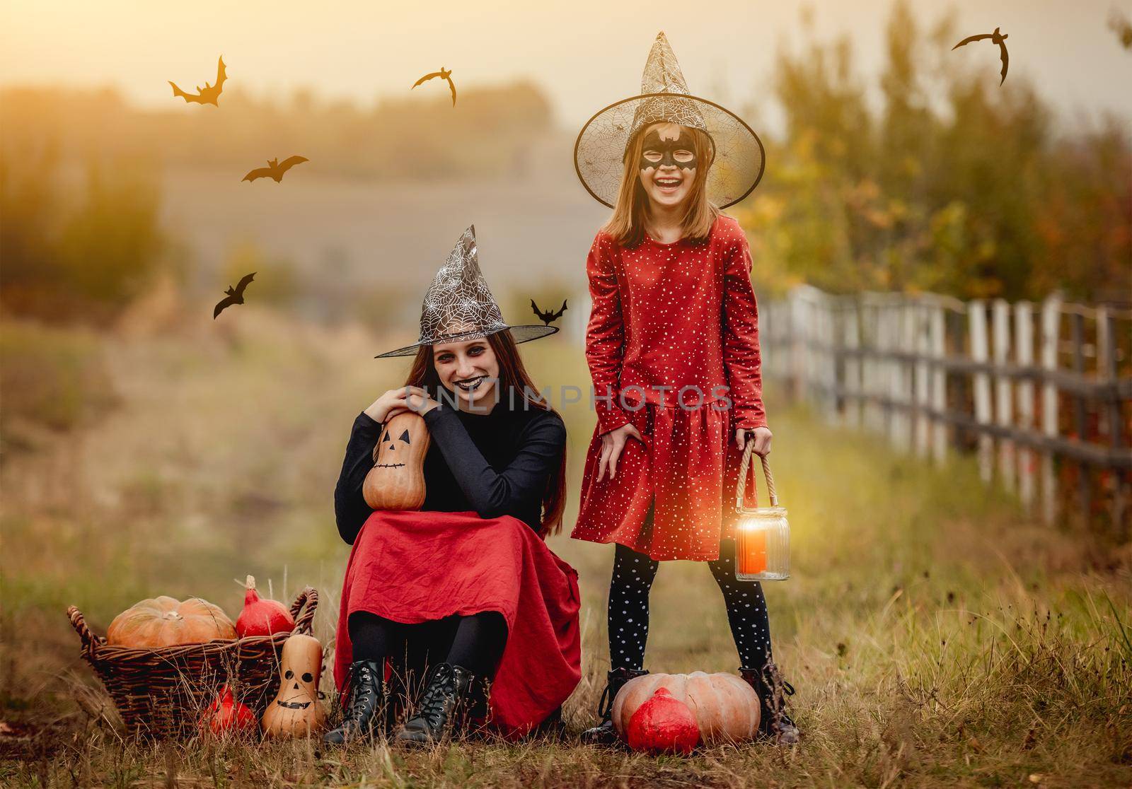 Children dressed for halloween with festive decorations on autumn nature background