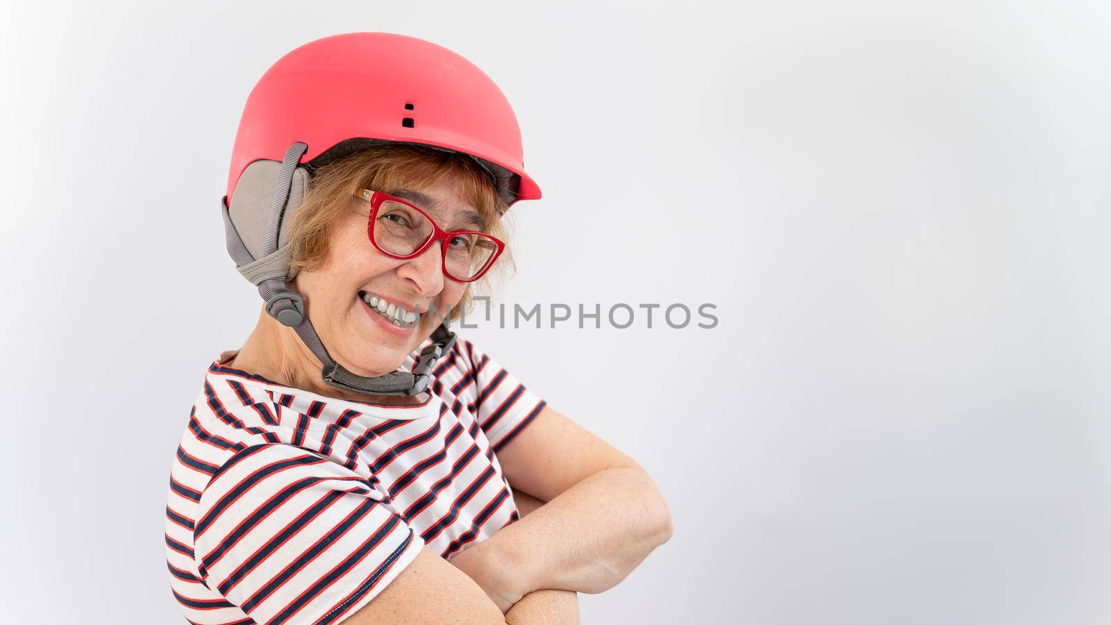Happy elderly woman in goggles and pink ski helmet on a white background by mrwed54
