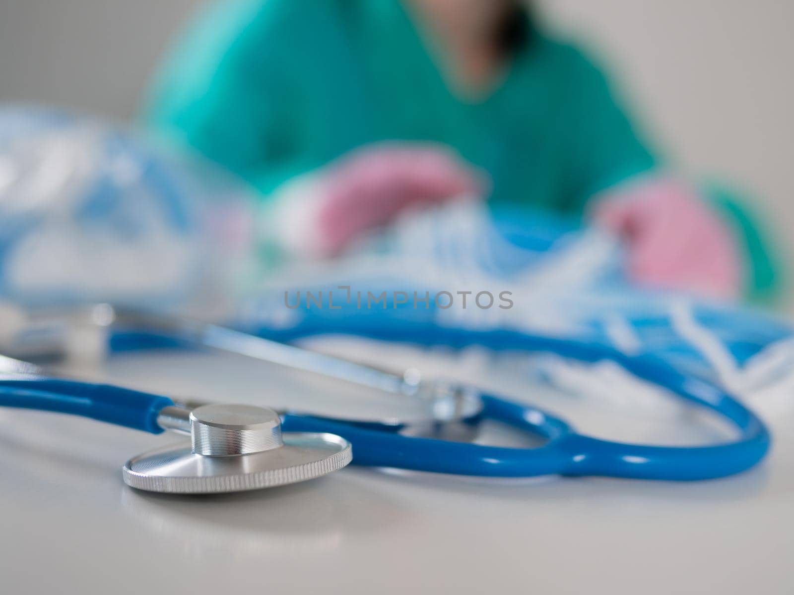 Counting the remaining medical masks in the doctor's office. Close-up of a stethoscope against the background of a doctor counting medical masks in the office. by Utlanov