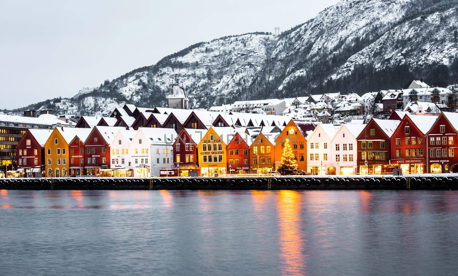 Bergen, Norway - December 29, 2014: Famous Bryggen street with wooden colored houses in Bergen at Christmas, Norway