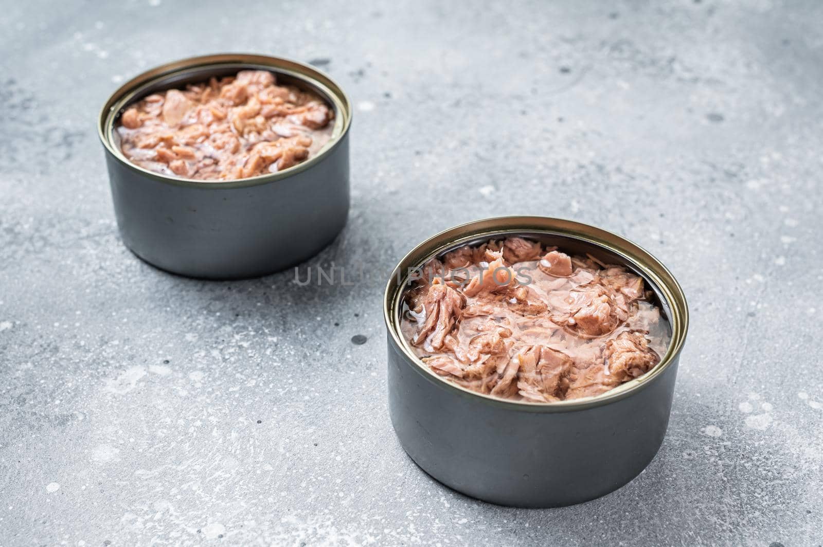 Open tin can with canned tuna fish. Gray background. top view by Composter