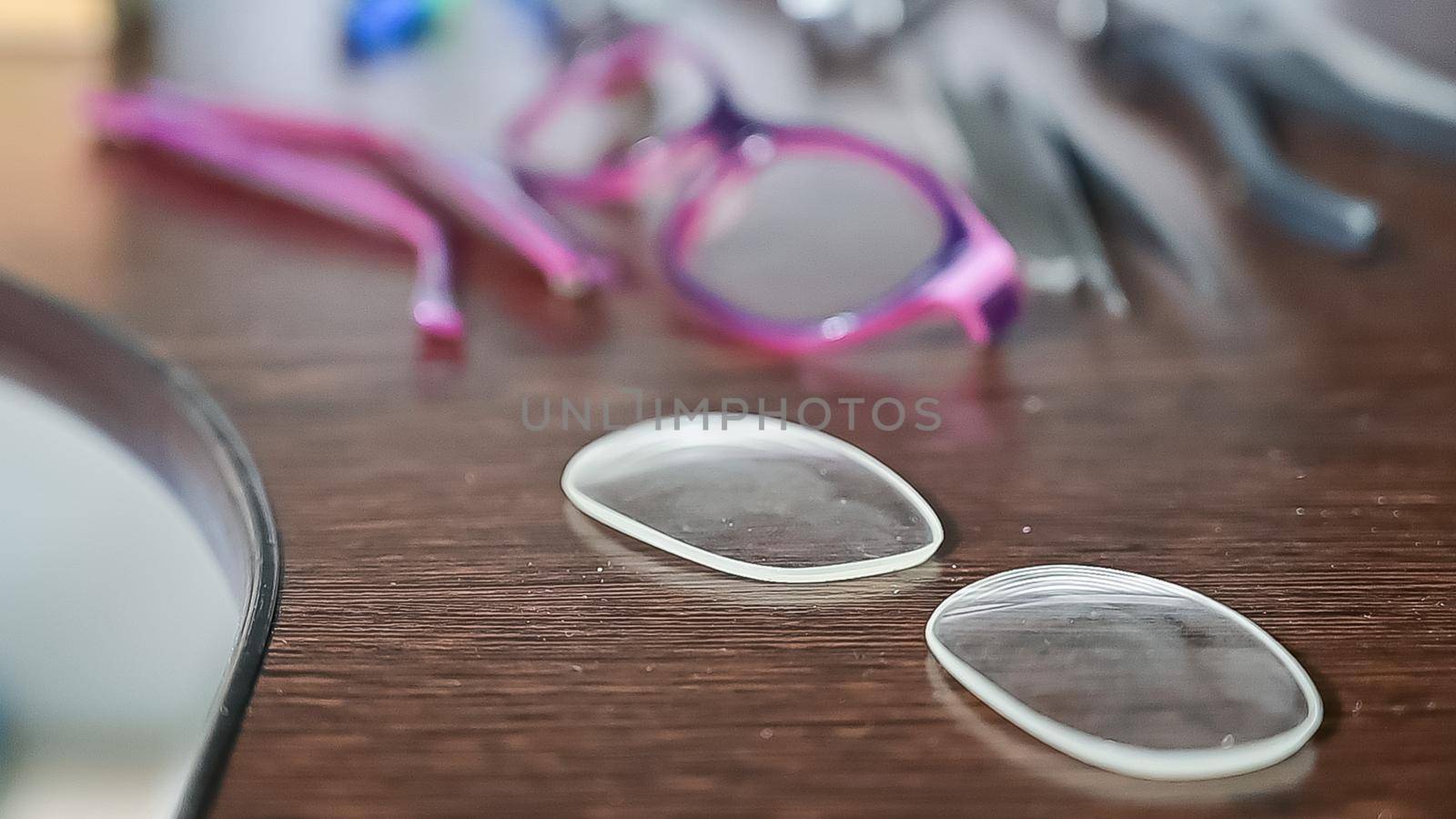 Optical technician work table. Close-up of lens frames and screwdrivers. by mrwed54
