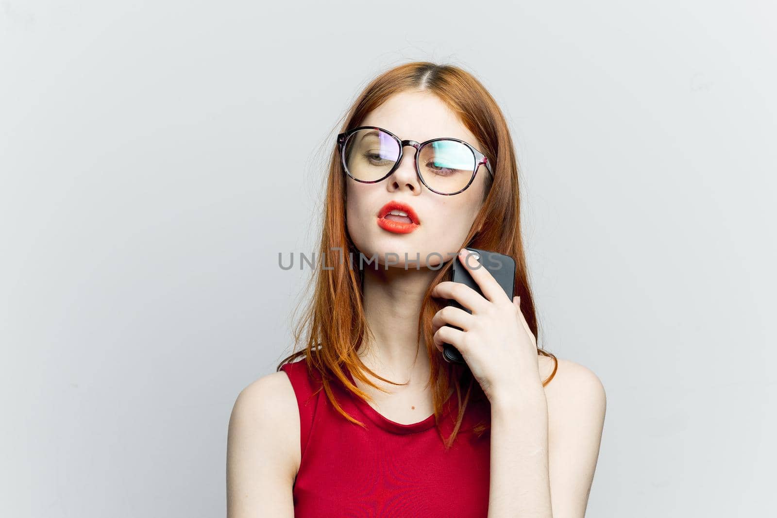 pretty woman in glasses with phone in hands communication technology. High quality photo